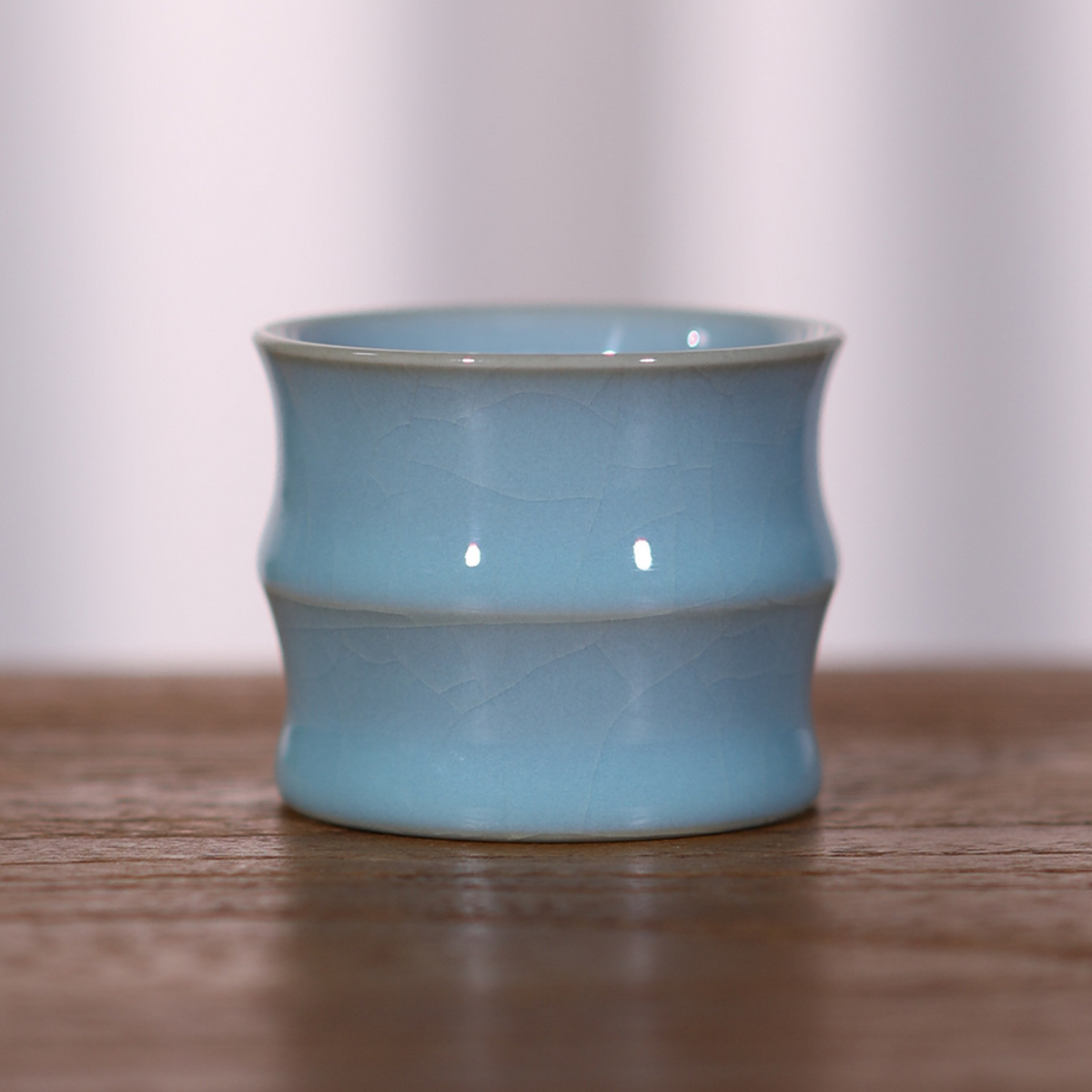 Sky Blue Bamboo-Joint Ru Porcelain Tea Cup on wooden table